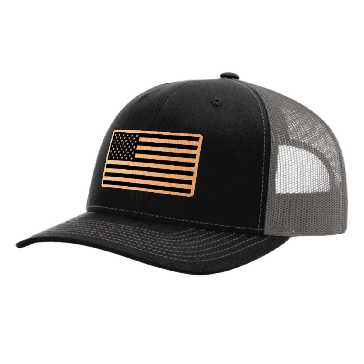 A black and charcoal trucker hat with a brushed copper acrylic patch on the front featuring an American flag design with black accents.