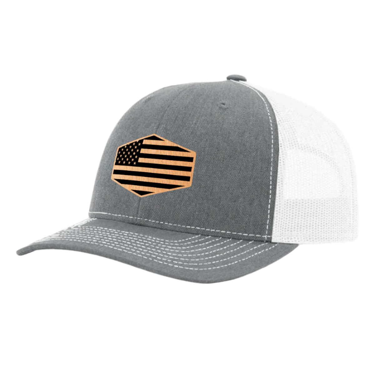 A heather gray and white trucker hat with a brushed copper acrylic patch on the front featuring an American flag design with black accents.