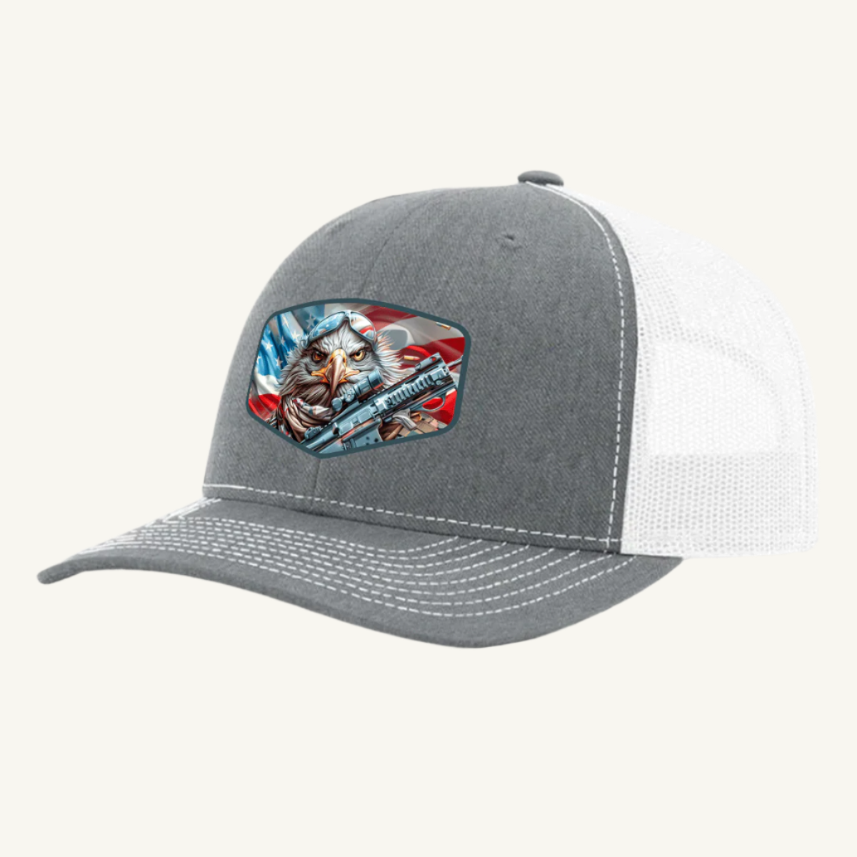 A heather gray and white mesh back hat with a leatherette patch featuring an eagle and stripes, reminiscent of the American flag.