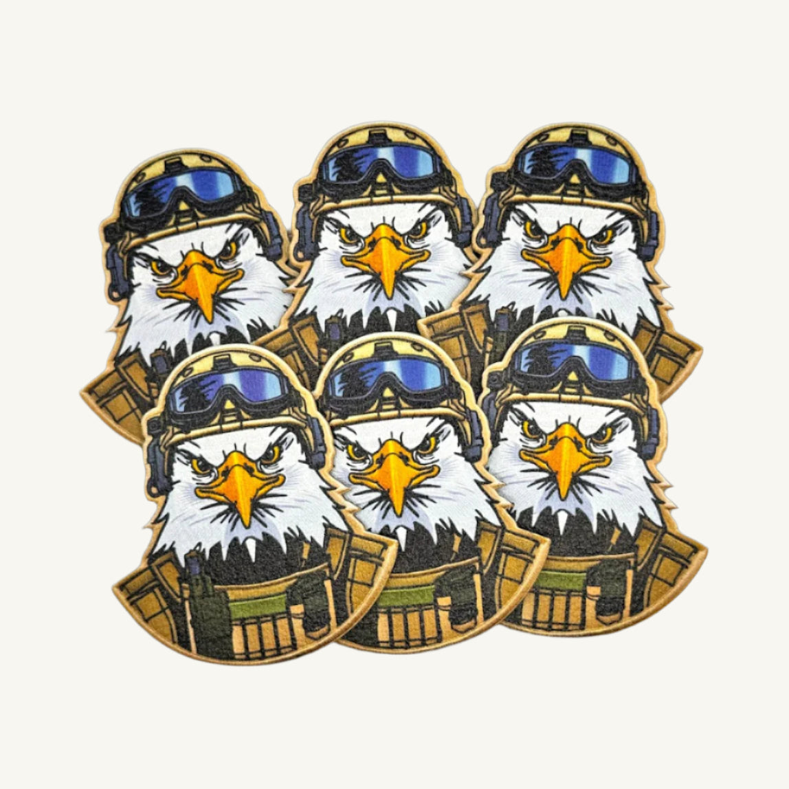 Multiple patches with a UV printed design of a bald eagle wearing a military helmet.