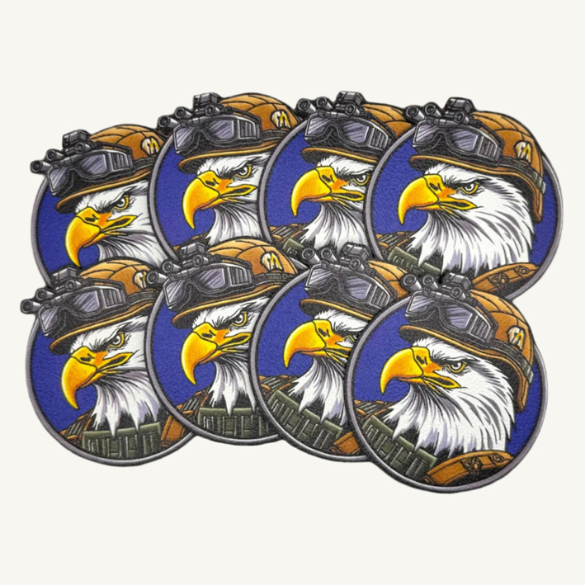 Multiple circular patches with a UV printed design of a bald eagle wearing a military helmet.