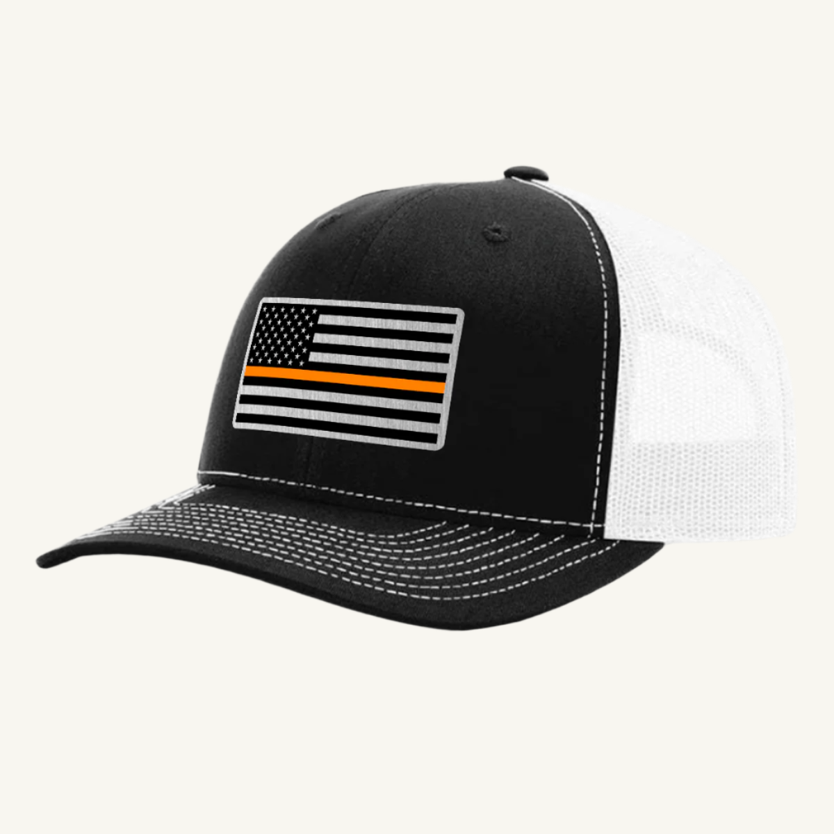 A black and white trucker hat with an acrylic patch on the front featuring the Thin Orange Line American Flag.