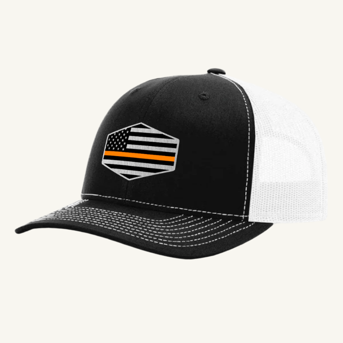 A black and white trucker hat with an acrylic patch on the front featuring the Thin Orange Line American Flag.