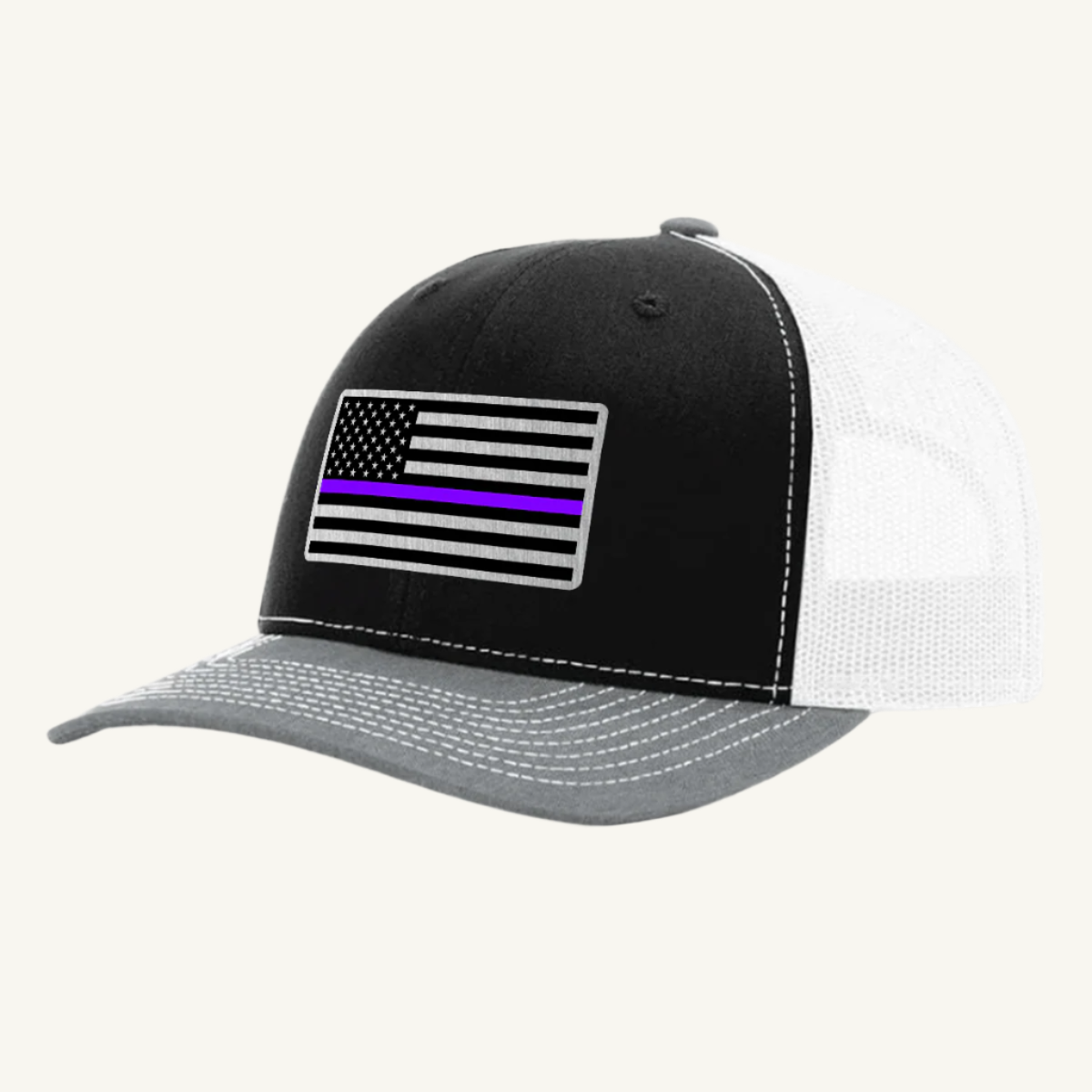 A black, gray, and white trucker hat with an acrylic patch on the front featuring the Thin Purple Line American Flag.