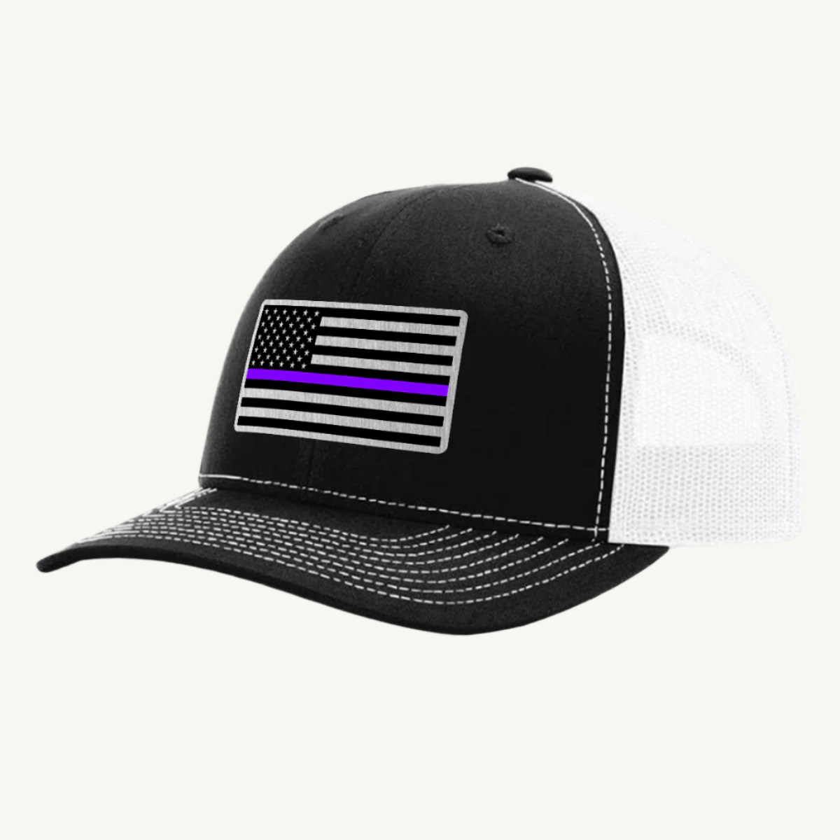 A black and white trucker hat with an acrylic patch on the front featuring the Thin Purple Line American Flag.