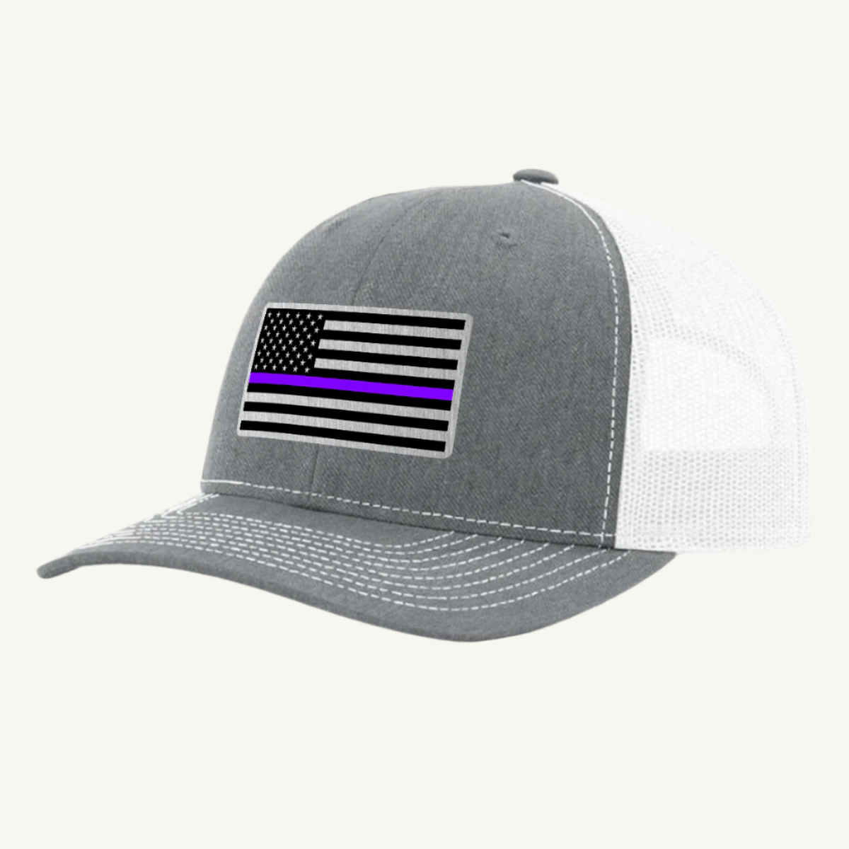 A heather gray and white trucker hat with an acrylic patch on the front featuring the Thin Purple Line American Flag.