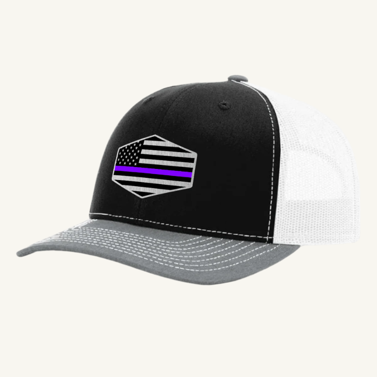 A black, gray, and white trucker hat with an acrylic patch on the front featuring the Thin Purple Line American Flag.