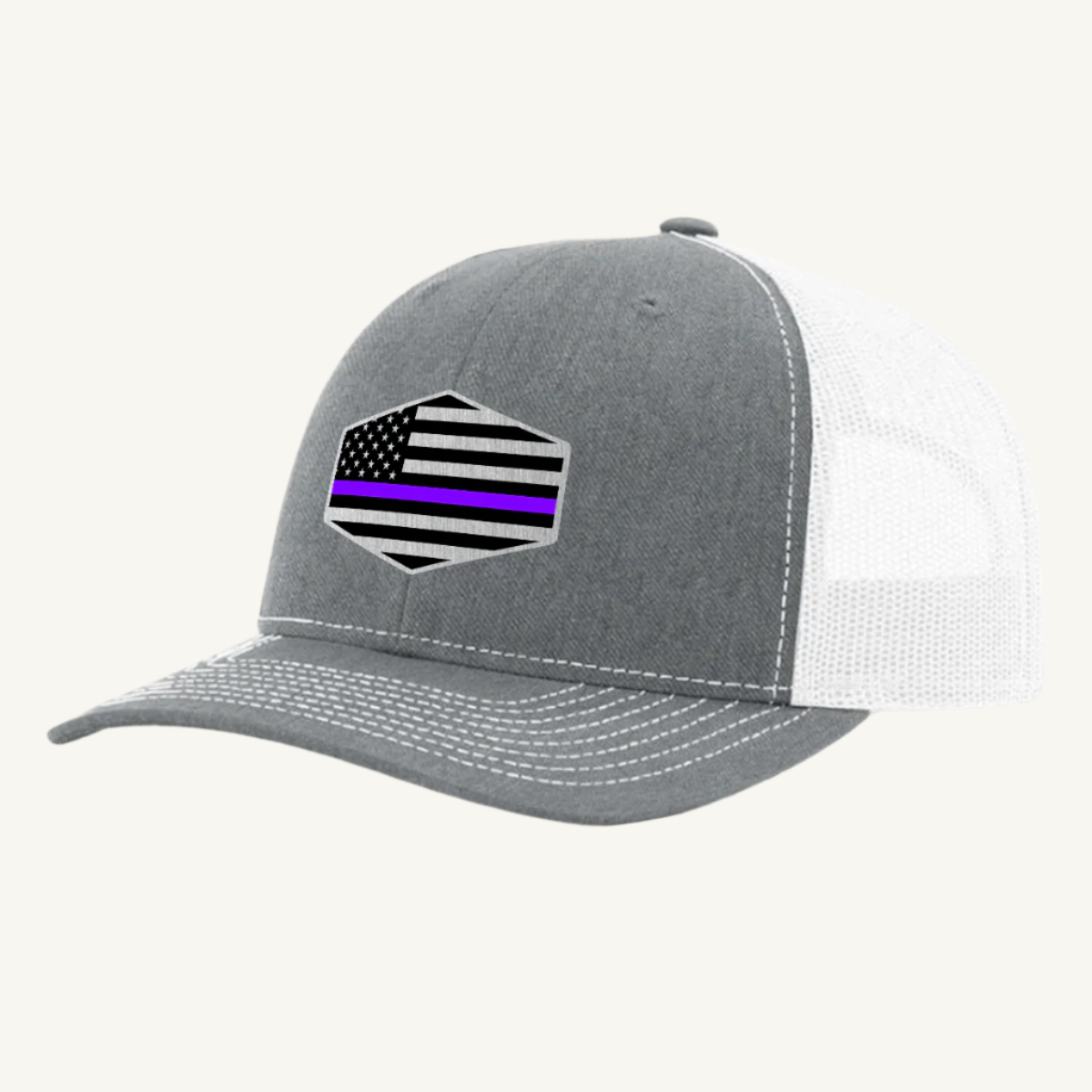 A heather gray and white trucker hat with an acrylic patch on the front featuring the Thin Purple Line American Flag.