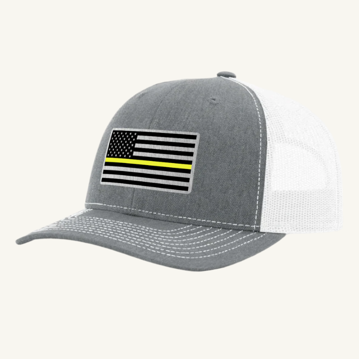 A heather gray & white trucker hat with a thin yellow line American flag acrylic patch on the front.