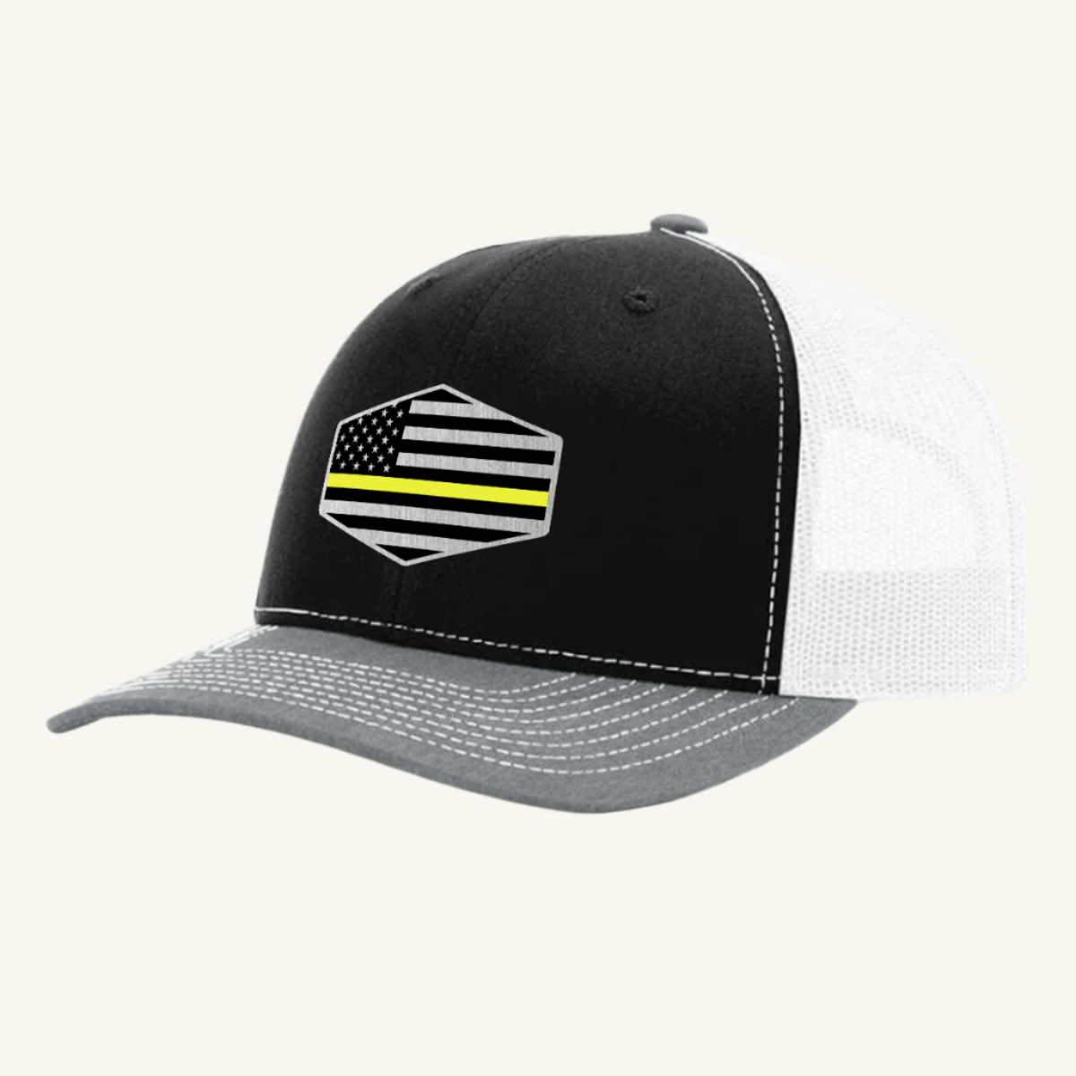 A black, heather gray, and white trucker hat with a thin yellow line American flag acrylic patch on the front.